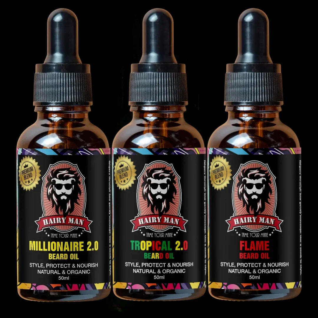 Three bottles of Hairy Man beard oil with colorful labels on a black background