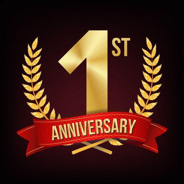 Gold 1st anniversary emblem with laurel wreath and red ribbon on dark background
