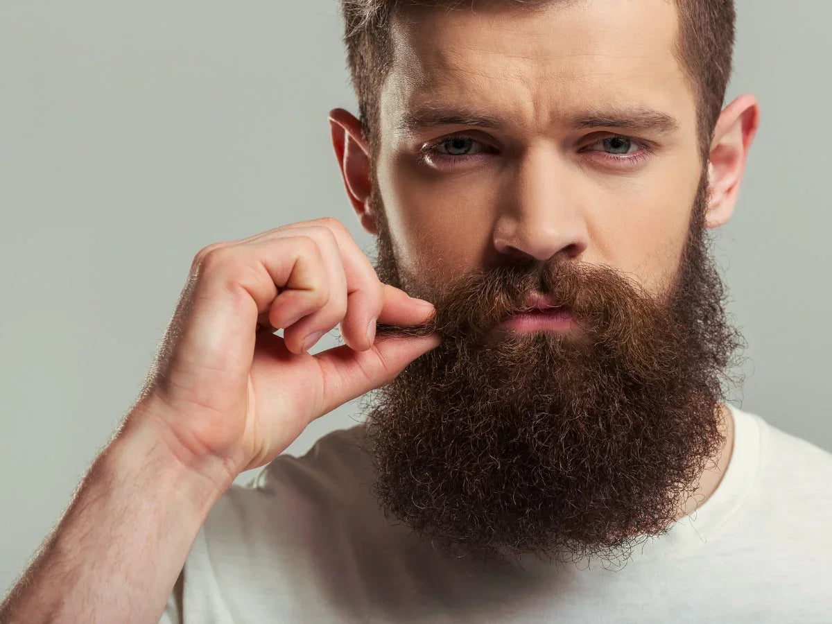 Man grooming thick beard and mustache, beard care and styling concept