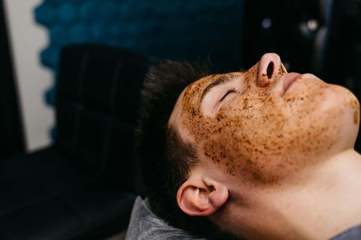 Man relaxing with natural exfoliating face mask at Hairy Man Care skincare salon