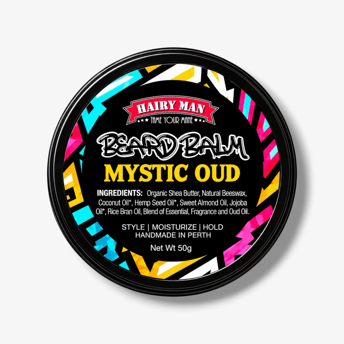 A round black tin of Hairy Man Beard Balm in the 'Mystic Oud' scent, featuring a colorful geometric pattern in pink, yellow, cyan, and white on the label, set against a clean white background with a soft drop shadow.