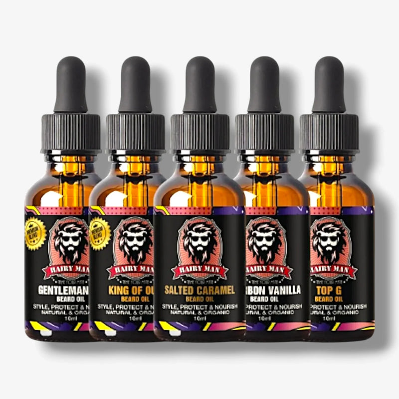Five bottles of natural beard oil with dropper caps, featuring scents like Salted Caramel and Bourbon Vanilla.