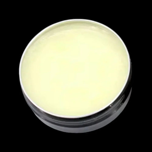 Hairy Man Care natural beard balm in tin against black background