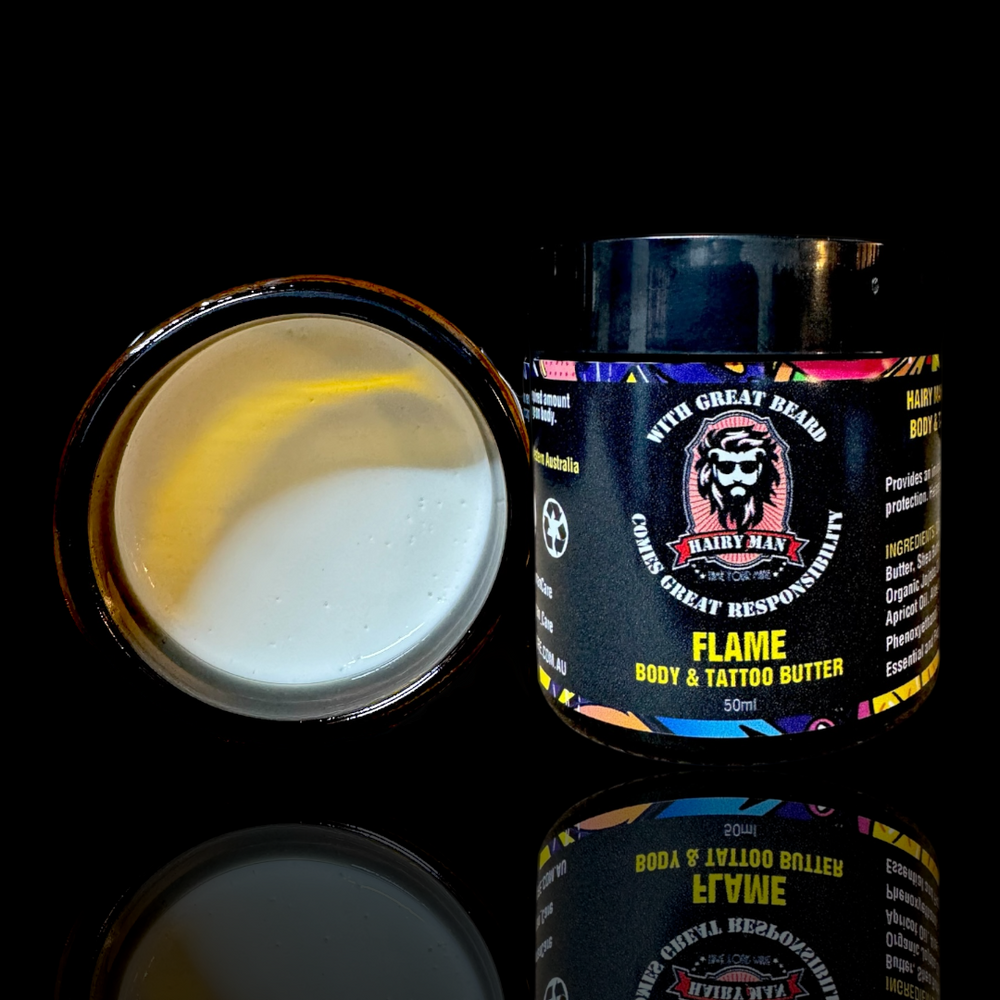 Jar of 'Flame' body and tattoo butter with a colorful label on a black background