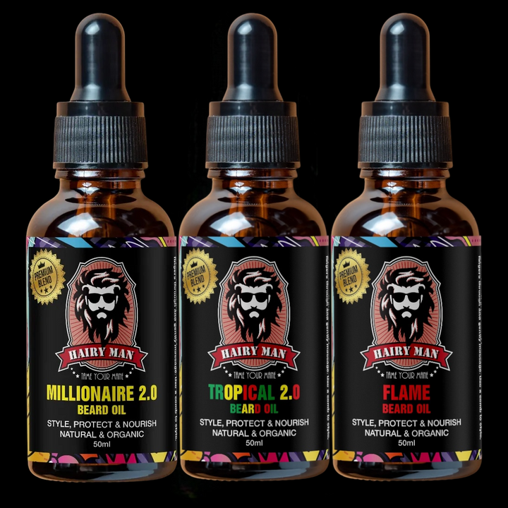 Three bottles of Hairy Man beard oil with colorful labels on a black background