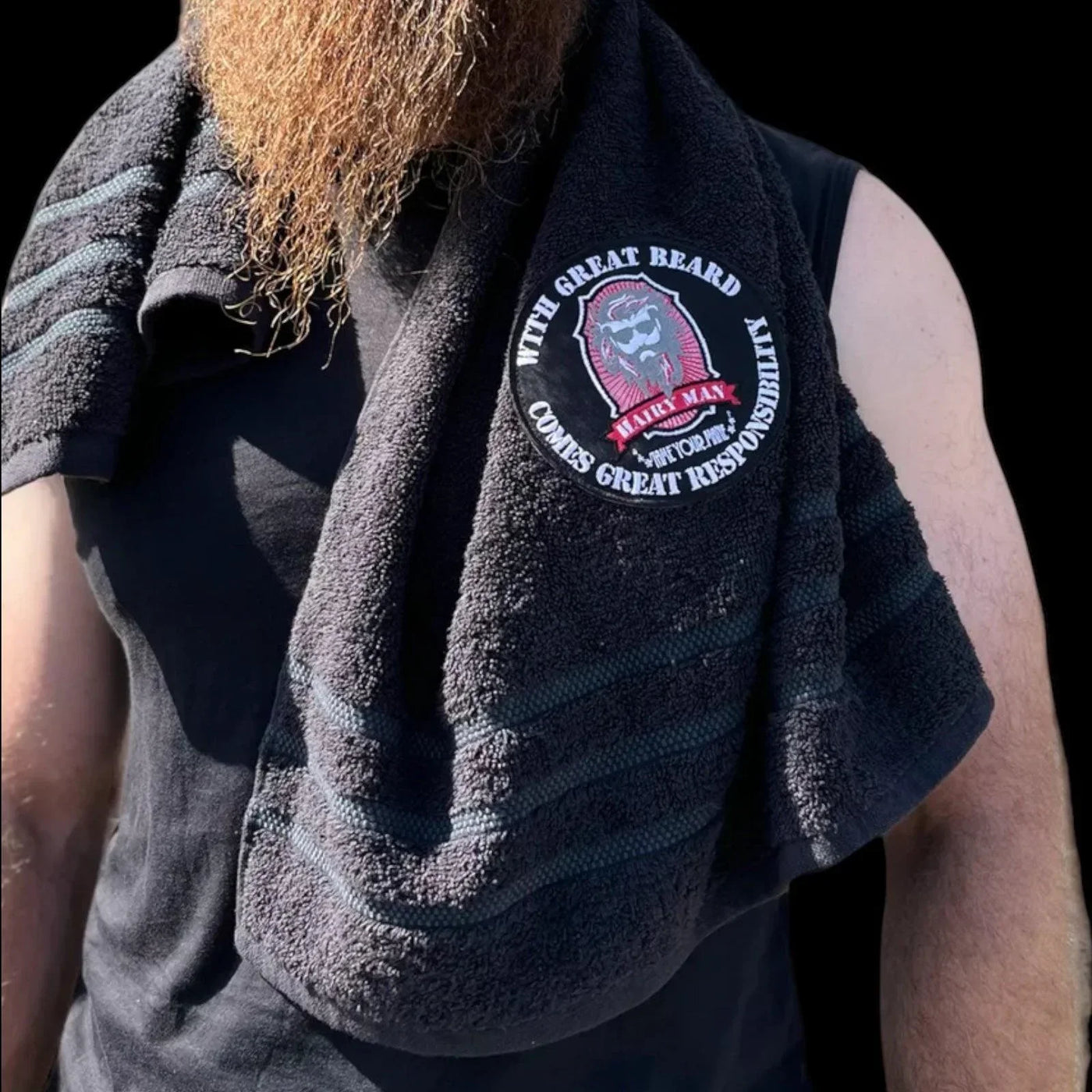 Man with long beard wearing black towel featuring 'With Great Beard Comes Great Responsibility' patch