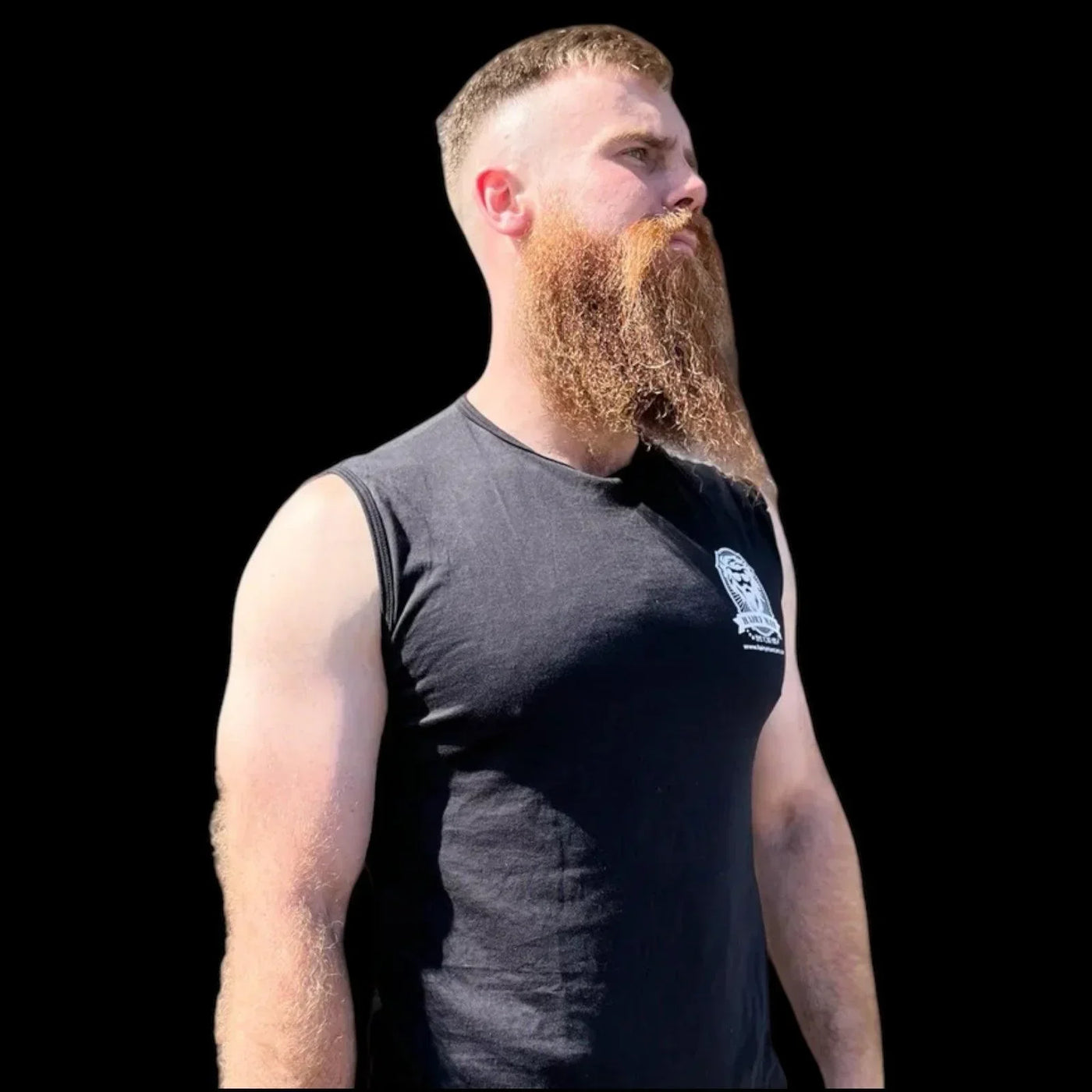 Man with thick, well-groomed red beard wearing black tank top, showcasing beard care results