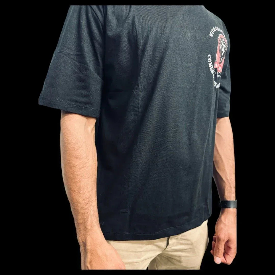 Man wearing dark gray graphic tee with lion logo on sleeve, paired with khaki shorts